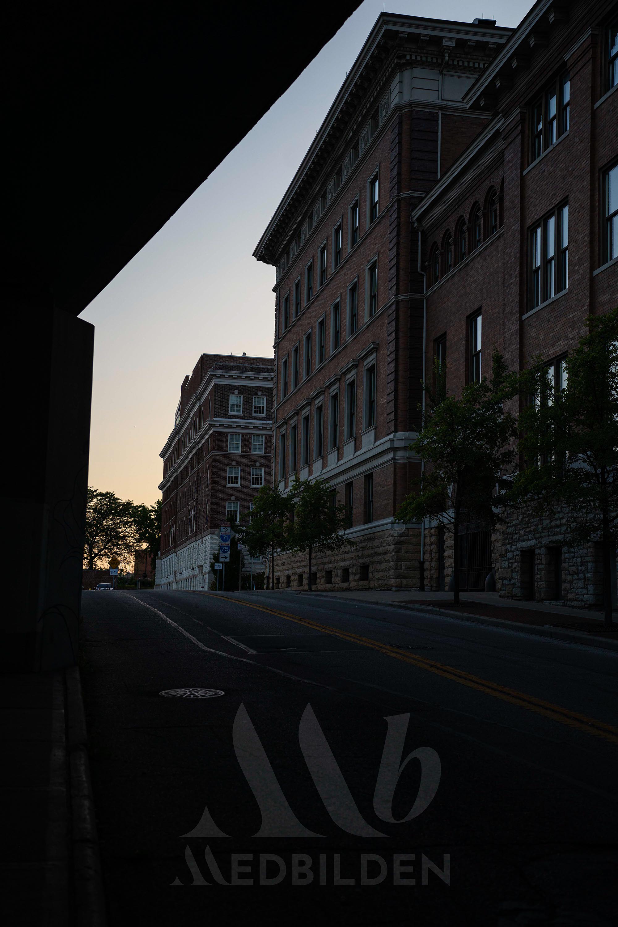 Downtown Cincinnati under a bridge at sunset