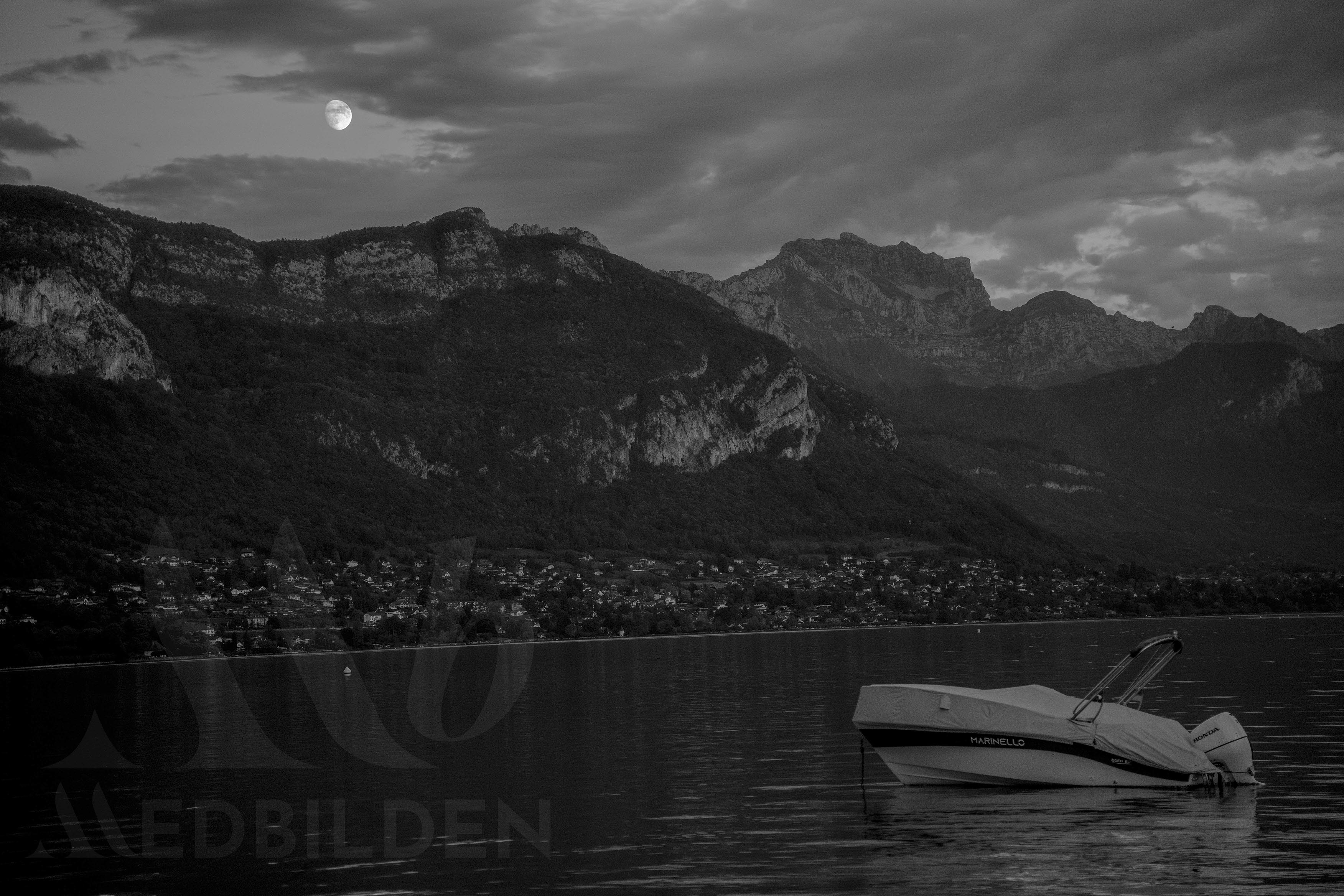 Lake Annecy at night under moonlight