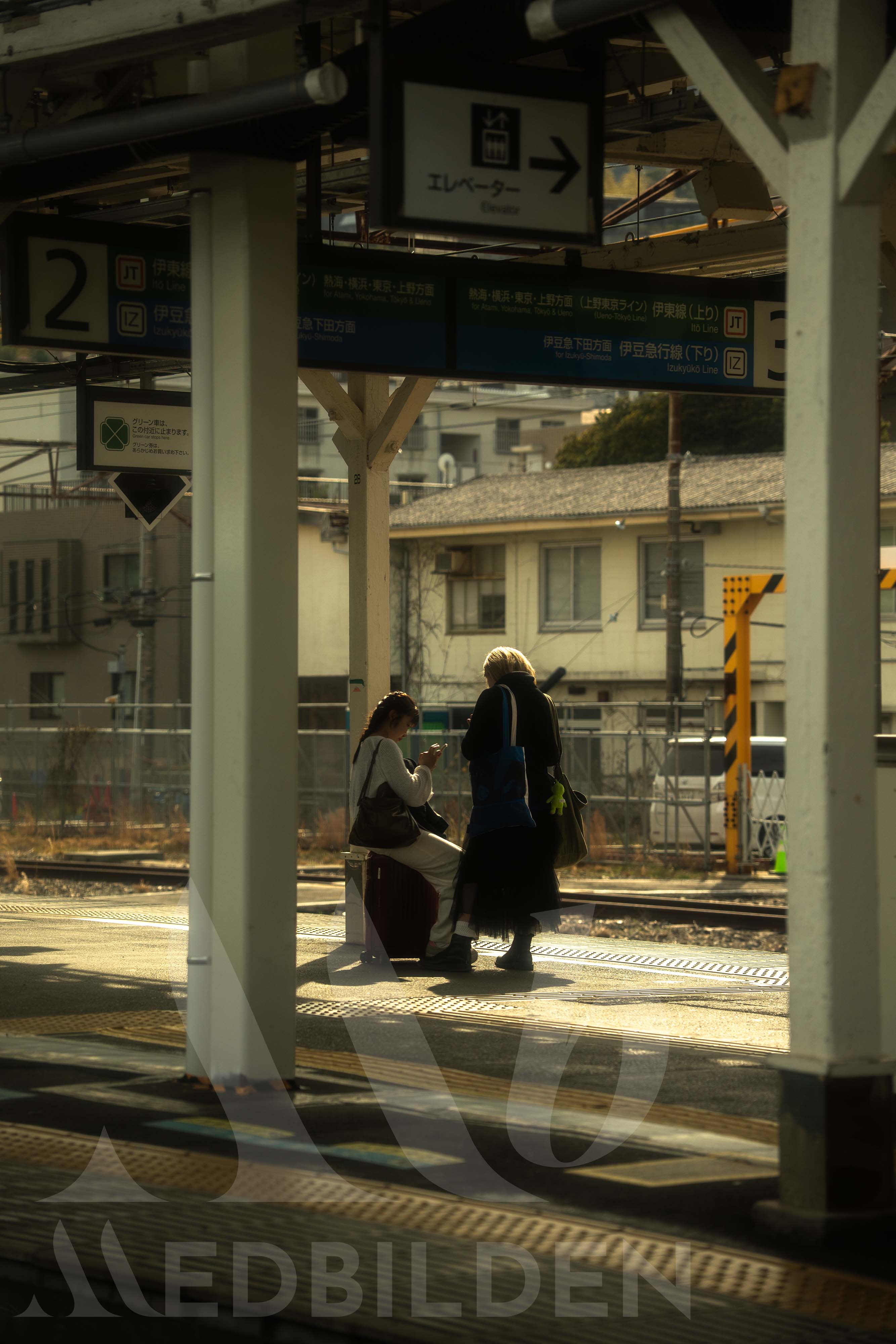 Commuters on a train station platform in Japan